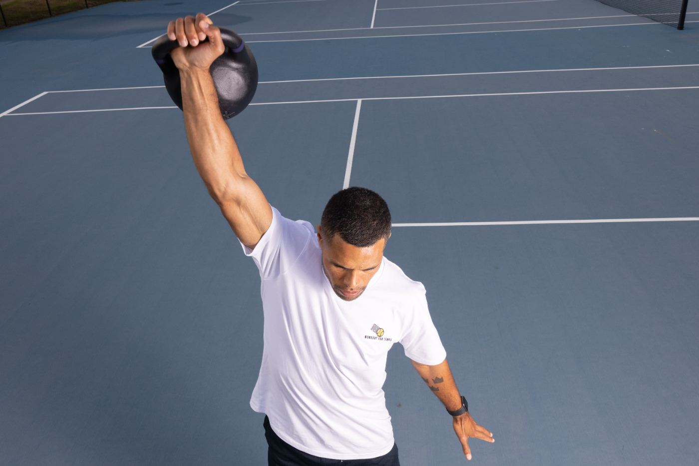 Athlete performing an explosive kettlebell swing off court