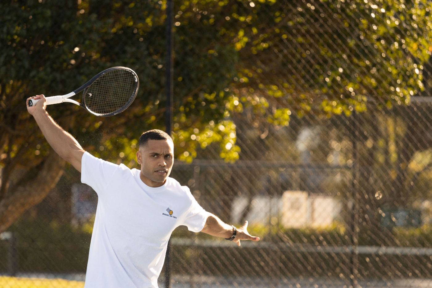 Tennis player striking an aggressive forehand on court